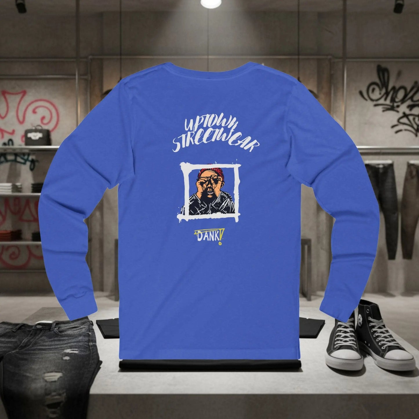 Blue long-sleeve shirt with graphic design on a mannequin in a store setting.