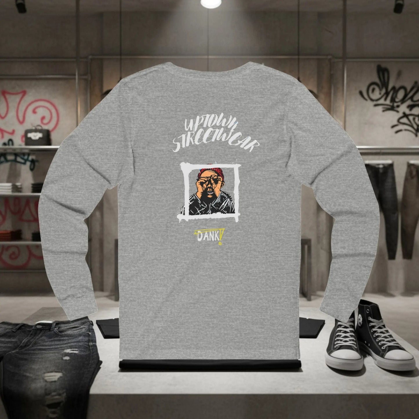 Gray long-sleeve shirt with graphic design on a mannequin in a store setting.