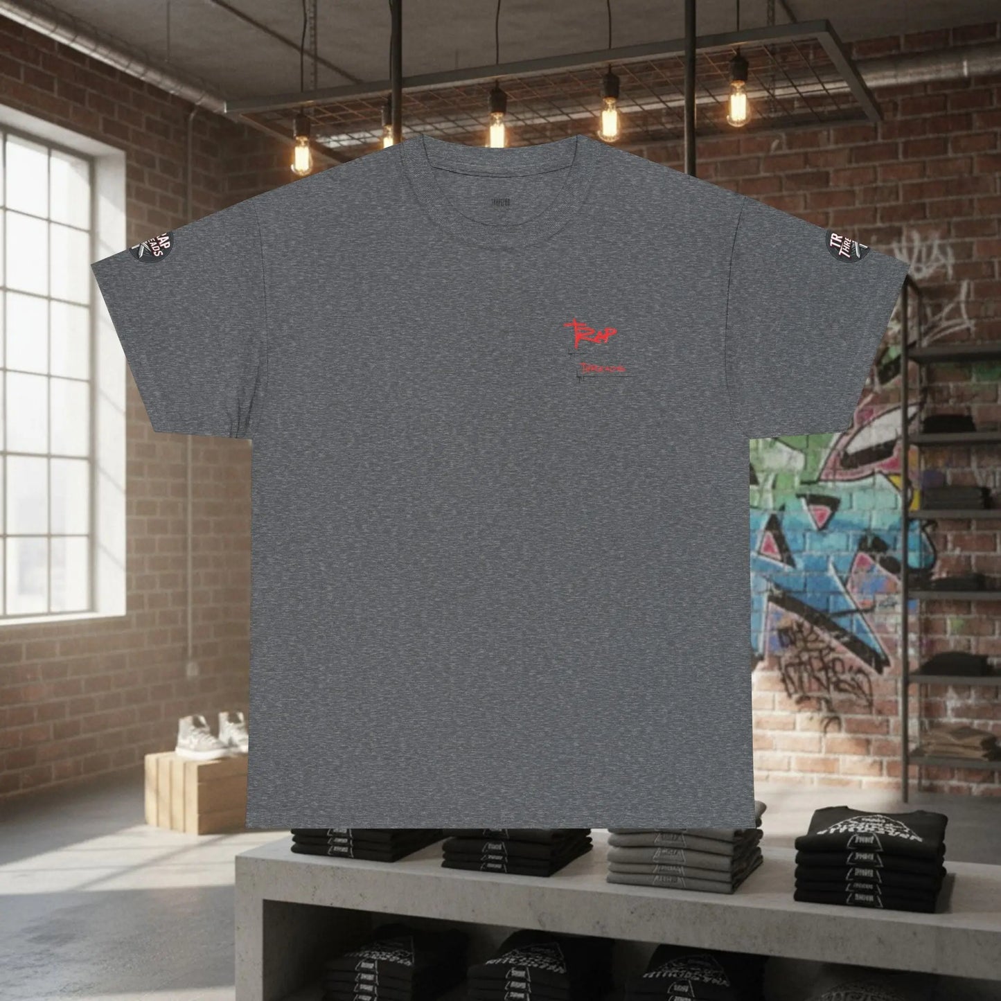 Gray t-shirt with a red logo on a table in an urban setting